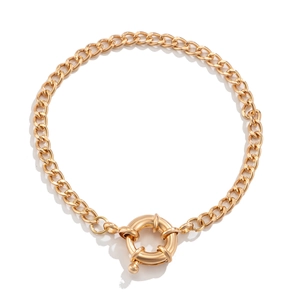 Detail of a vintage golden snake chain necklace featuring a polished round spring clasp