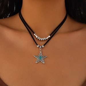 Detail of bohemian double-layer choker with silver star pendant and turquoise stone inlay