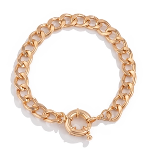 Detail of chunky gold snake bone chain link bracelet with decorative spring ring clasp