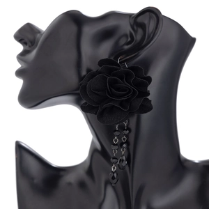 Gothic black fabric rose earrings with beaded tassels on an elegant silhouette stand