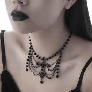 Macro detail of gothic tiered black bead necklace with elegant teardrop crystal pendants