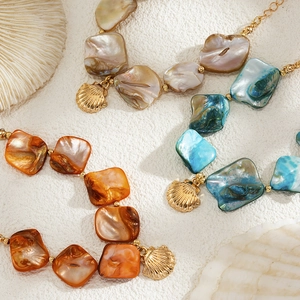 Detail of starfish necklaces with shell pendants and colorful beads in ocean style