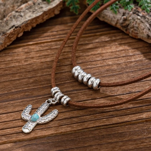 Vintage cactus necklace with blue turquoise stone and silver beads on a brown cord