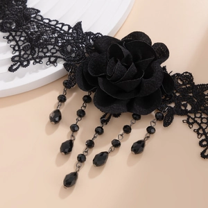 Detailed macro view of black lace rose choker with elegant beaded tassel fringe pendant