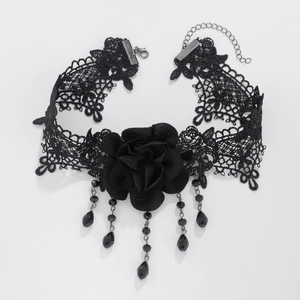 Macro shot of gothic black lace choker featuring rose detail and beaded tassels