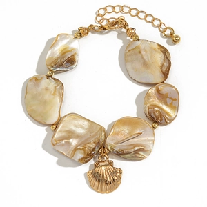 Macro di frammenti di conchiglia e ciondolo a conchiglia dorato su una collana