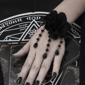 Detail of gothic black lace rose slave bracelet with beaded tassels and charms
