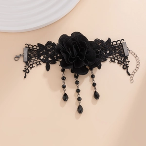 Detail of Gothic black lace choker featuring a 3D fabric rose and beaded fringe tassels