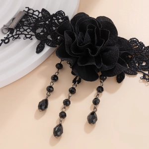 Detail of gothic black lace choker featuring a textile rose and beaded tassel pendants