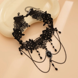 Close-up of gothic black lace choker with hanging chains and faceted teardrop beads
