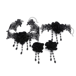 Gothic black lace jewelry set featuring fabric roses and bead tassels on white background