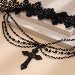Detail of gothic lace choker with black crystal beads and vintage cross pendant