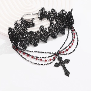 Close-up of gothic lace choker with red crystal beads and black cross pendant