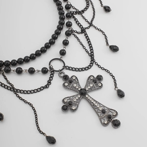 Macro shot of gothic cross body chain featuring black beads and shimmering rhinestones