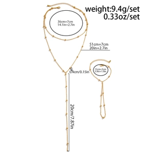 Detailed view of gold beaded Y-necklace and hand chain set with exact size measurements