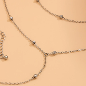 Minimalist silver beaded chain necklace with adjustable link and polished metallic beads