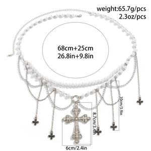 Detailed view of layered silver waist chain with pearl beads and ornate cross pendants