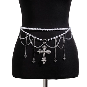 Detailed view of silver waist chain featuring white pearls and rhinestone cross pendant