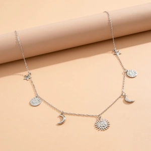 Macro detail of silver starfish and shell charms with faux pearls on a body chain