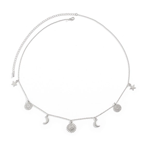 Detail of silver body chain featuring celestial sun moon and star charms on white background