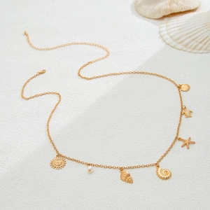 Detailed shot of golden beach waist chain with seashell, starfish, and turtle charms