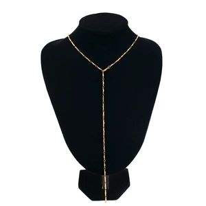 Detail view of a long gold Y-shaped textured link chain on a black velvet neck display
