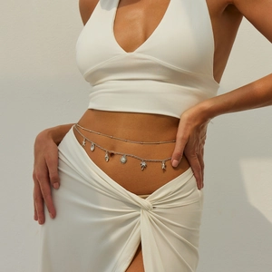 Detail of silver double-layered body chain featuring starfish, shell and palm tree charms