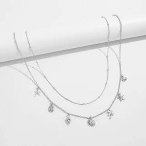 Detail of silver body chain with layered shells, starfish and palm tree charms