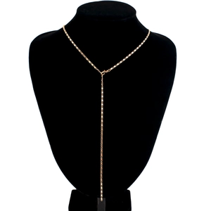 Detailed view of golden Y-shaped lariat necklace with square links on black neck model