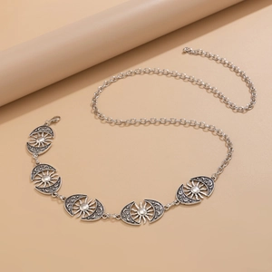 Detail of vintage silver body chain with sun and moon embossed metal plates