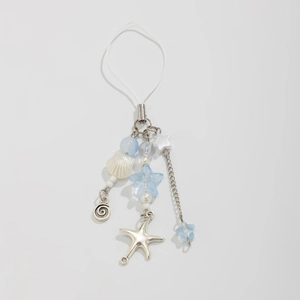 Detail of ocean-themed phone strap featuring silver starfish, shells, and blue star beads