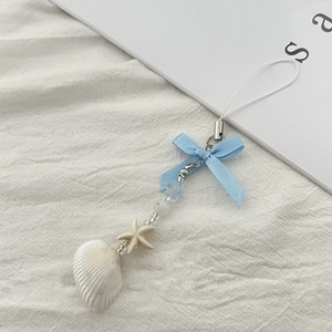 Detailed shot of ocean-style phone strap with blue bow, small starfish and white seashell
