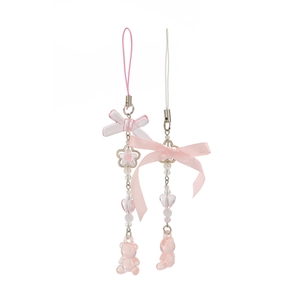 Close-up of cute pink bow charms with strawberry and acrylic bear beads on silver chains