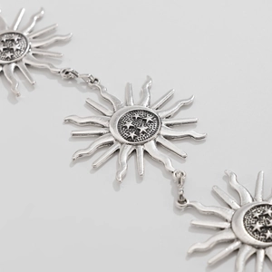 Detailed close-up of antique silver waist chain with celestial sun moon and star charms