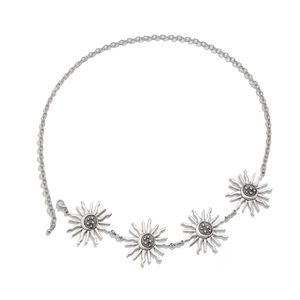 Detail of vintage silver sun and star medallions on a bohemian gothic style waist chain