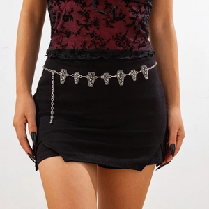 Close-up of silver gothic waist chain featuring detailed coffin pendants and skull textures
