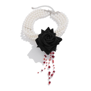Multilayer pearl choker with black rose and red beaded tassels on a profile silhouette