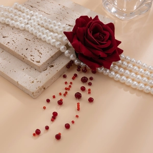 Detail of four-row pearl necklace with red velvet rose and flowing beaded tassels