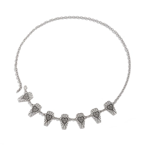 Detailed macro view of Gothic silver body chain with coffin charms and lobster clasp