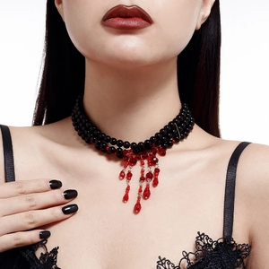 Close-up of gothic layered black beaded choker with red crystal droplet fringe detail