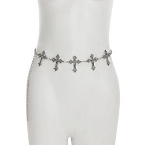 Detailed macro view of silver cross charms and adjustable chain on a metal body belt