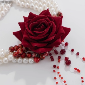 Macro detail of gothic bloody pearl necklace with red velvet rose and layered tassels