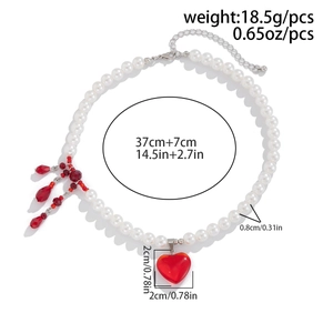 Detailed view of multilayer pearl necklace with red heart pendant and crystal tassels