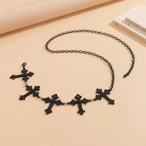 Detail view of Gothic matte black body chain featuring five ornate hollow cross pendants