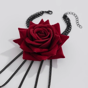 Gothic red velvet rose necklace detail featuring hanging black tassels and rich texture