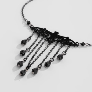 Detail of gothic black bat necklace with fringed chain tassels and beaded charms