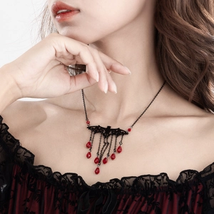 Close-up of gothic bat pendant with black tassel chains and red teardrop crystal beads