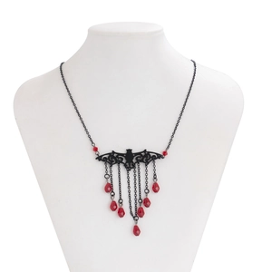 Detailed macro view of Gothic bat pendant necklace with red crystal teardrop tassels