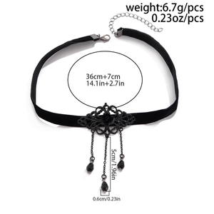 Detail view of black velvet choker with gothic floral metalwork and beaded fringes
