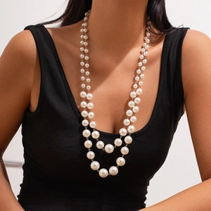 Elegant double-layered faux pearl necklace with silver-tone chain on a model